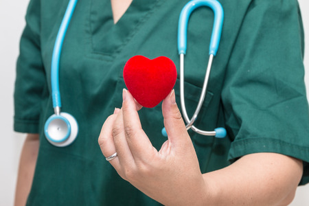 Doctor's hand holding a heart shape