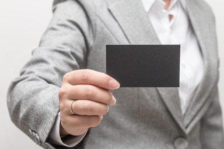 Woman's hand holding a business cardの写真素材