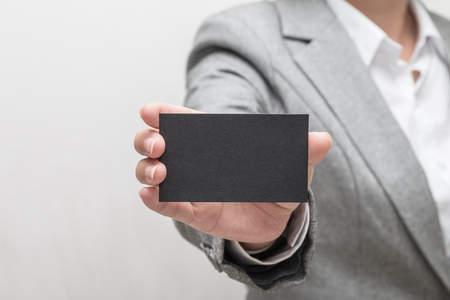 Woman's hand holding a business cardの写真素材