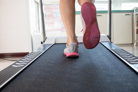 Woman doing fitness on a treadmill