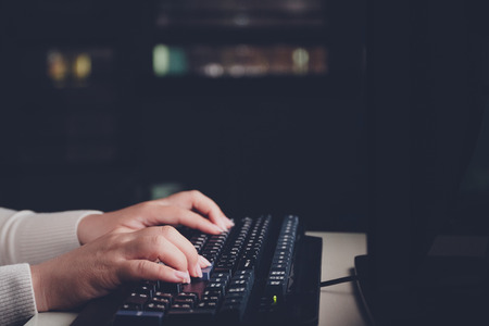 Businesswoman working overtime at night in the officeの写真素材