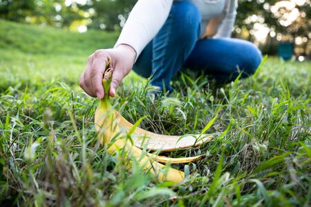 Pick up banana peel trashの写真素材