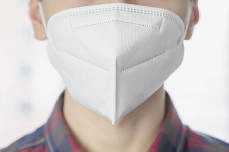 Asian young man wearing protective maskの写真素材