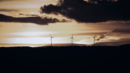 Wind turbines at sunset in a wind farm in the Czech Republic.
