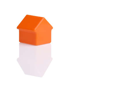 orange small plastic toy house isolated on white backgroundの写真素材