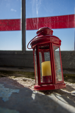 Lantern with a candle against the sky in the old lighthouseの写真素材