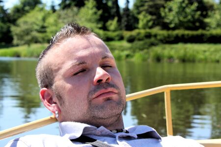 Resting man in boatの写真素材