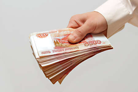 a bundle of money in the hand of a man