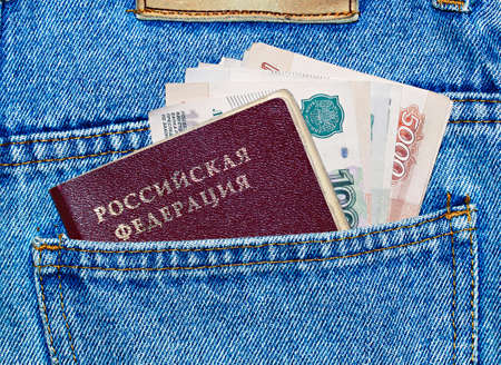 money and passport in the back pocket of jeansの写真素材