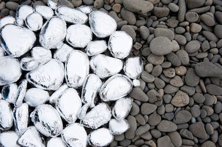 circle of stones on the beach covered with foil 