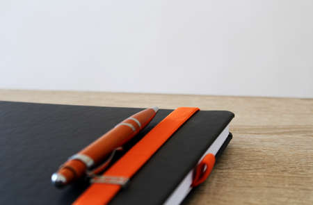 Pen with paper block on the tableの写真素材