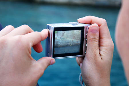 Woman makes photo with camera on the holiday
