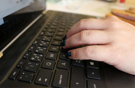 Woman is writing on her black notebookの写真素材