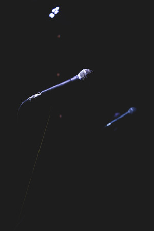 Microphone on stage against a background of auditoriumの写真素材