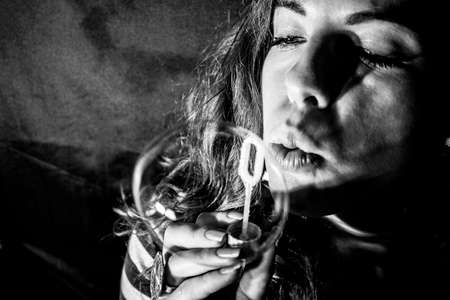 girl blowing soap bubbles, closeup portrait beautifulの写真素材