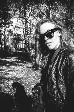 Girl in forest with sunglassの写真素材