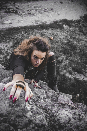 Girl climbing on the rockの写真素材