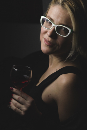 Isolated girl hold in hand glass of wineの写真素材