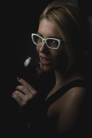 Isolated girl hold in hand glass of wineの写真素材