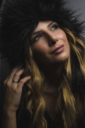 Female Posing in Studio with Women's fur shapkaの写真素材