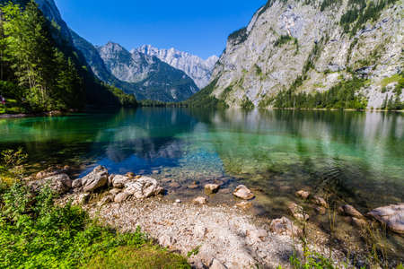 Beautiful landscape of alpine lake with crystal clear green water and mountains in background, Gosausee, Austriaの写真素材