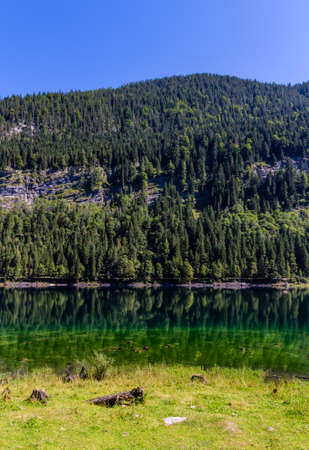 Beautiful landscape of alpine lake with crystal clear green water and mountains in background, Gosausee, Austriaの写真素材