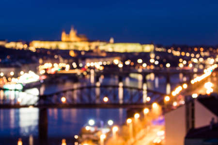 Defocused bokeh of Prague and Vltava river from Vysehrad - Romantic view after misty sunset with emotional color filter - European capital of bohemian Czech Republicの写真素材