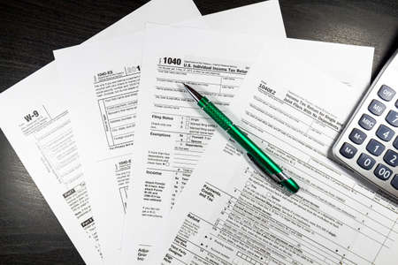 US tax form 1040 with pen and calculator. Tax form law document, business conceptの写真素材
