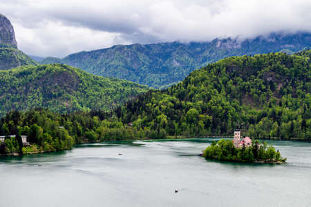 Lake Bled with St. Marys Church of Assumption on small island. Bled, Slovenia, Europe. Mountains and valley on background. Areal view from above.のeditorial素材