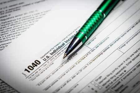 US tax form 1040 with pen and calculator. Tax form law document, business conceptの写真素材