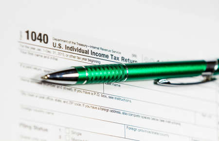 US tax form 1040 with pen and calculator. Tax form law document, business conceptの写真素材