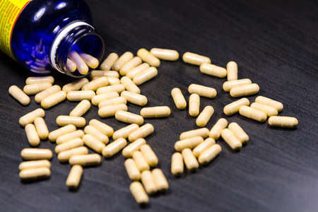 Capsules with bootle isolated on black backgroundの写真素材