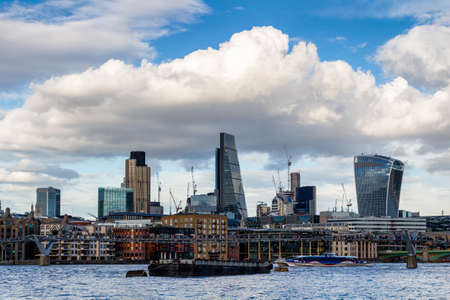 Business district with famous skyscrapers and landmarks at golden hour, London, UKの写真素材