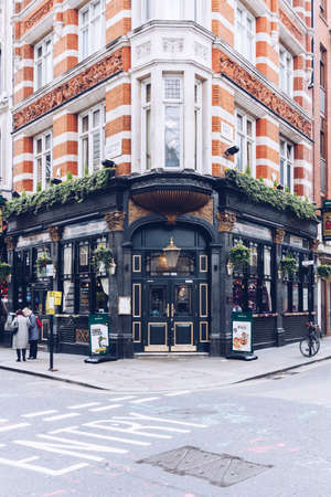 London, UK - April 1, 2017: Facade of Greene King, typical british pub in the central London