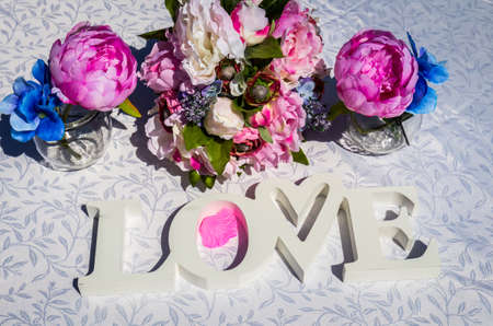 Creative layout with colorful flowers, leaves and Word LOVE. Love concept.の写真素材