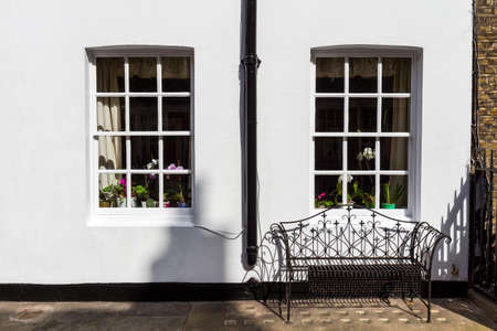 Typical street scene in the central London district with familiar architecture facades to urban housing.の写真素材