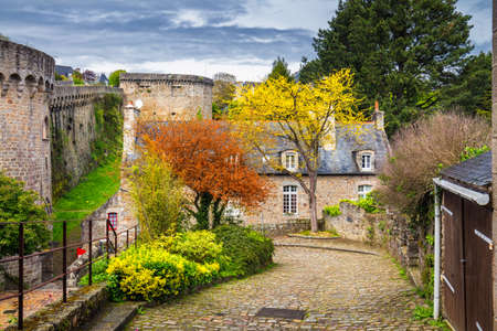 Narrow street with old traditional houses in histoical part of Dinan, Brittany (Bretagne), Franceのeditorial素材