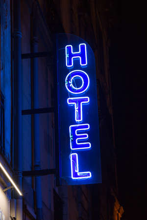 Blue neon hotel sign in the nightの写真素材