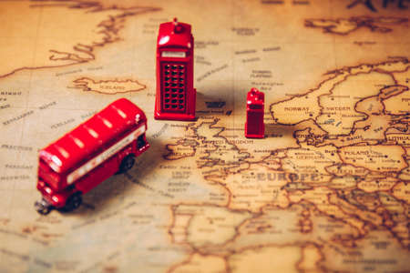The iconic red bus and Big Ben miniature with compass on the map of London, UK. Concept of travel.の写真素材
