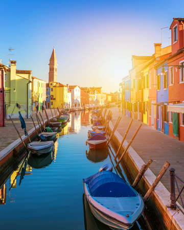 Street with colorful buildings in Burano island, Venice, Italy. Architecture and landmarks of Burano, Venice postcard. Scenic canal and colorful architecture in Burano island near Venice, Italyの写真素材