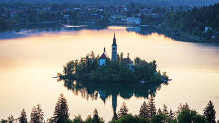 Dramatic sunrise on lake Bled, sunrise view on Bled lake, island, Pilgrimage Church of the...