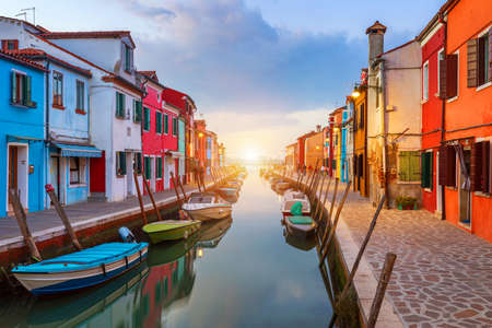 Beautiful view of the canals of Burano with boats and beautiful, colorful buildings. Burano village is famous for its colorful houses. Venice, Italy.の写真素材