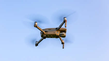 Drone flying over landscape. UAV drone copter flying with digital camera. Drone flying overhead in...