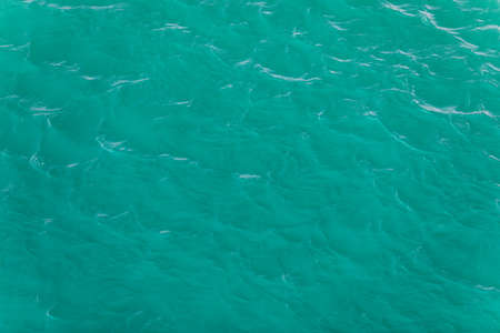 Background shot of aqua sea water surface. Sea surface aerial view. Waving water surface of the sea...