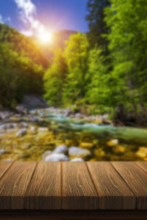 Empty wooden table in front of abstract blurred background in nature, can be used for display or montage your products. Mock up for display of productの写真素材