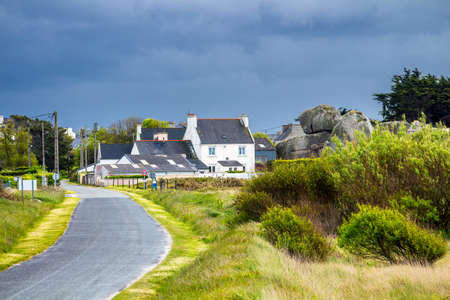 Ocean coast in Meneham village with granite rocks and boats, Kerlouan, Finistere, Brittany (Bretagne), Franceの写真素材