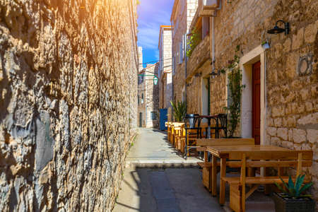Beautiful street with flowers in the Hvar town, Hvar island, Dalmatia, Croatia. Old Mediterranean street, Hvar town. Old Adriatic town Hvar. Medieval street. Popular touristic destination of Croatia.の写真素材