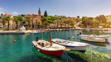 Fishing boats in Splitska village with beautiful port, Brac island, Croatia. Village of Splitska on Brac island seafront view, Dalmatia, Croatia, Croatia.の写真素材