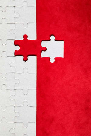 Jigsaw puzzle with missing piece. Missing puzzle pieces. Concept image of unfinished task. Completing final task, missing jigsaw puzzle pieces and business concept with a puzzle piece missing.の写真素材