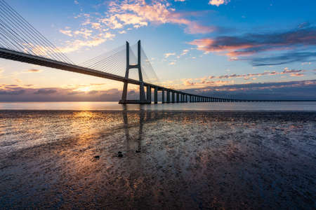 Vasco da Gama bridge at sunrise in Lisbon, Portugal. Vasco da Gama bridge in Lisbon by sunrise, Portugal. Sunrise at Lisbon, looking to the Vasco da Gama Bridge. Lisbon, Portugal.の写真素材